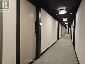 Burlington (Lasalle) condo for rent - A long hallway with doors on both sides and lights on the ceiling.