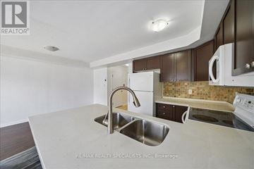 Mississauga (Cooksville) townhouse for rent - A kitchen with a sink and a refrigerator.