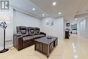 Mississauga (Churchill Meadows) apartment for rent - A living room with a brown leather sofa and a wooden coffee table.