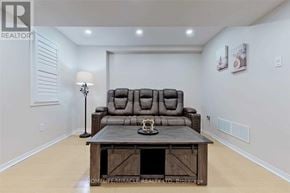 Mississauga (Churchill Meadows) apartment for rent - A living room with a brown couch and a wooden coffee table.