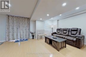 Mississauga (Churchill Meadows) apartment for rent - A living room with a brown leather couch and a wooden coffee table.