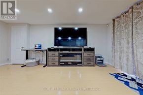 Mississauga (Churchill Meadows) apartment for rent - A living room with a flat screen TV and a cabinet with drawers.