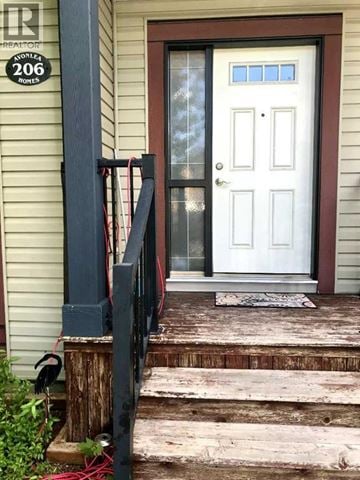 Lethbridge apartment for rent - A white door with a glass window is on the front of a house.