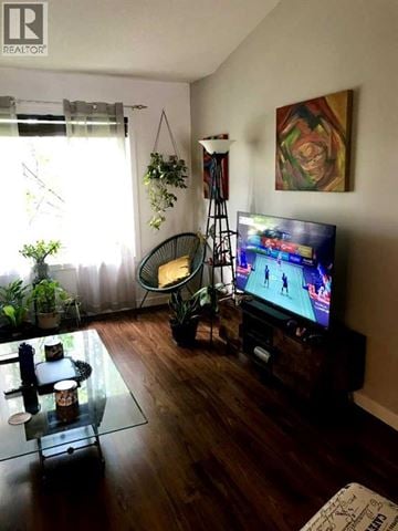 Lethbridge apartment for rent - A living room with a television and a glass table.