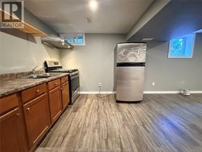 Windsor apartment for rent - A kitchen with wooden floors and a stainless steel refrigerator.