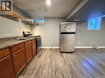 Windsor apartment for rent - A kitchen with wooden floors and a stainless steel refrigerator.