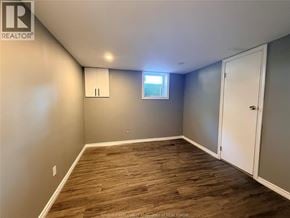 Windsor apartment for rent - A room with wooden flooring and a window with blinds.