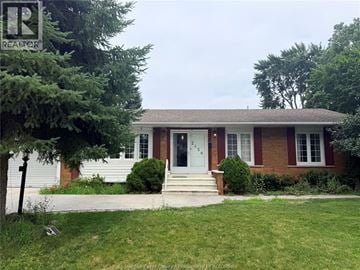 Windsor apartment for rent - A house with a red brick exterior and a white door is for sale.