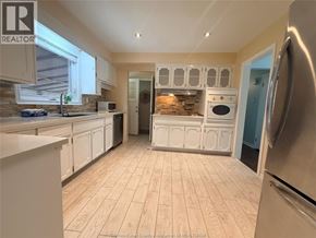 Windsor apartment for rent - A kitchen with white cabinets and a wooden floor.