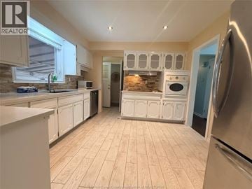 Windsor apartment for rent - A kitchen with white cabinets and a wooden floor.