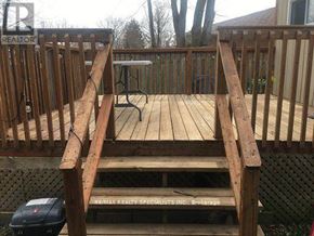Mississauga (Clarkson) apartment for rent - A wooden deck with a bench and a table.