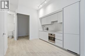 Toronto (Thorncliffe Park) condo for rent - A white kitchen with a white oven and white cabinets.