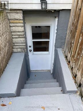 Toronto (South Riverdale) apartment for rent - A white door with a glass window is set in a grey wall.