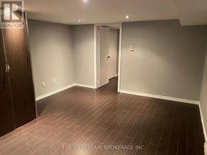 Toronto (South Riverdale) apartment for rent - A room with a wooden floor and a door in the middle.