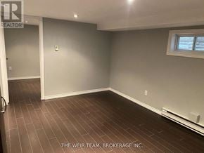 Toronto (South Riverdale) apartment for rent - A room with a wooden floor and a window.