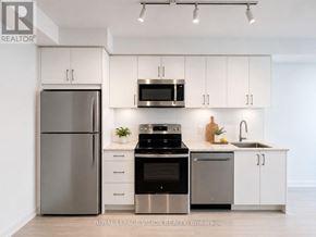 Toronto (Humber Heights) condo for rent - A modern kitchen with stainless steel appliances and white cabinets.