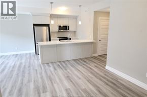 Lakeshore condo for rent - A kitchen with a fridge, microwave, and a countertop.