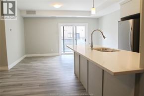 Lakeshore condo for rent - A kitchen with a sink and a refrigerator.