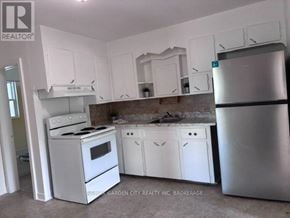 Welland (Lincoln/Crowland) multi-family for rent - A kitchen with white appliances and cabinets.