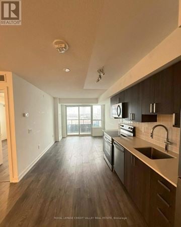 Pickering (Bay Ridges) condo for rent - A kitchen with dark wood floors and a stainless steel dishwasher.