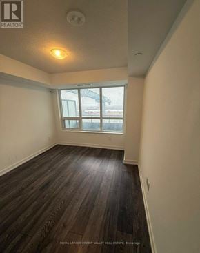Pickering (Bay Ridges) condo for rent - A room with wooden flooring and a window overlooking a snowy landscape.