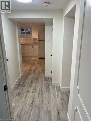 Kitchener apartment for rent - A hallway with wood flooring and white walls.