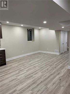 Brampton (Bram East) apartment for rent - A room with wooden flooring and a white wall.