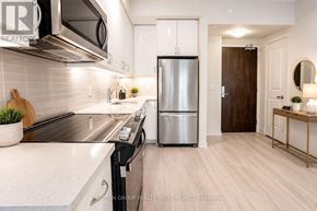 Toronto (Mimico) condo for rent - A modern kitchen with a refrigerator, sink, and stove.
