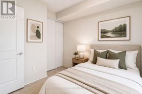 Toronto (Mimico) condo for rent - A bedroom with a large bed and two pictures on the wall.