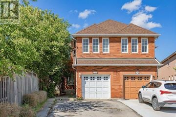 Mississauga (Meadowvale Village) apartment for rent - A red brick house with a white garage door and a white car parked in front.