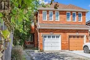 Mississauga (Meadowvale Village) apartment for rent - A red brick house with a white garage door.