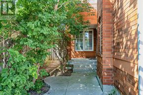 Mississauga (Meadowvale Village) apartment for rent - A small garden area with a brick wall and a glass door.