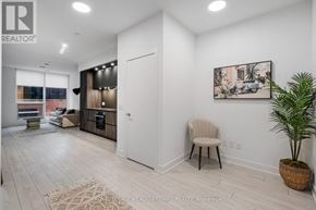 Toronto (Waterfront Communities) condo for rent - A room with a white door, a chair, and a potted plant.