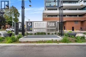Kitchener condo for rent - A parking sign for Wellington St South is displayed in front of a building.