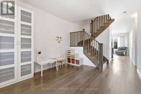 Hamilton (Stoney Creek Mountain) apartment for rent - A living room with a staircase and a white sofa.