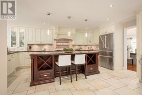 Hamilton (Carlisle) apartment for rent - A kitchen with a center island and white chairs.