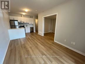 Niagara Falls (Morrison) condo for rent - A kitchen with white cabinets and a wooden floor.