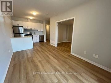 Niagara Falls (Morrison) condo for rent - A kitchen with white cabinets and a wooden floor.
