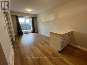 Niagara Falls (Morrison) condo for rent - A room with wooden flooring and a white cabinet.