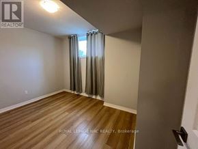 Niagara Falls (Morrison) condo for rent - A room with wooden flooring and a window with curtains.