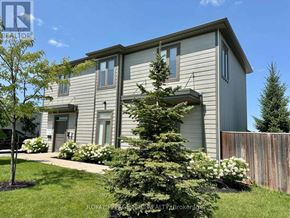 St. Catharines (Oakdale) apartment for rent - A house with a grey siding exterior and a white door.