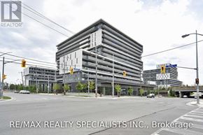 Toronto (Englemount-Lawrence) condo for rent - A large building with the words RE/MAX Realty Specialists Inc., Brokerage on the side of it.