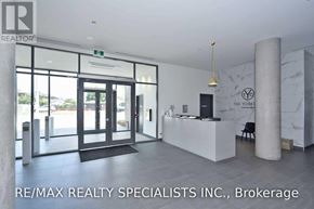 Toronto (Englemount-Lawrence) condo for rent - A real estate office with a white reception desk and a green exit sign.
