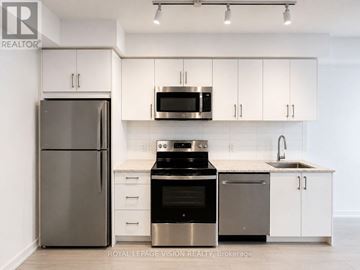 Toronto (Humber Heights) condo for rent - A kitchen with white cabinets and stainless steel appliances.
