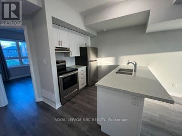 Niagara Falls (Morrison) condo for rent - A kitchen with a white counter top and cabinets.