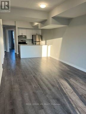 Niagara Falls (Morrison) condo for rent - A spacious room with wooden flooring and white walls.