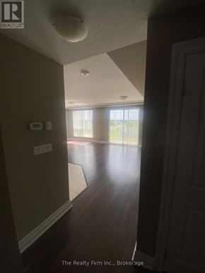 Woodstock (Woodstock - South) condo for rent - A hallway with a door on the right and a window on the left.