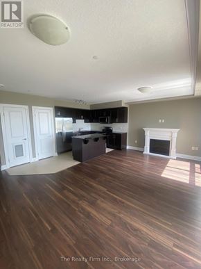 Woodstock (Woodstock - South) condo for rent - A living room with wood flooring and a fireplace.
