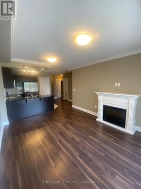 Woodstock (Woodstock - South) condo for rent - A living room with a fireplace and wood flooring.