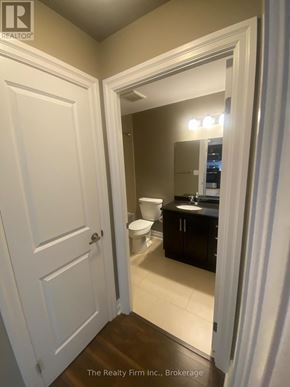 Woodstock (Woodstock - South) condo for rent - A bathroom with a toilet, sink and mirror.